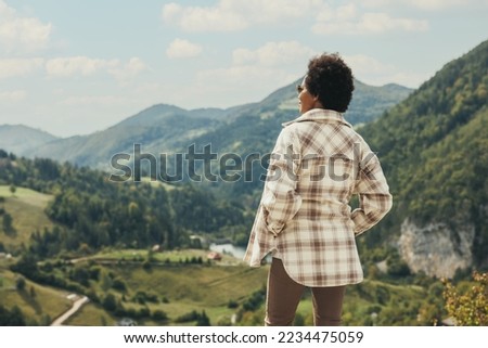 Similar – Image, Stock Photo Black woman traveler standing on rocky cliff