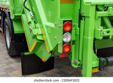 Rear View Of A Brand New Garbage Truck With Loading Bay, On A Parking Lot