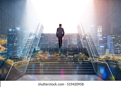 Rear view of a businessman climbing stairs to get to a large city center. Concept of success and appreciation. Double exposure