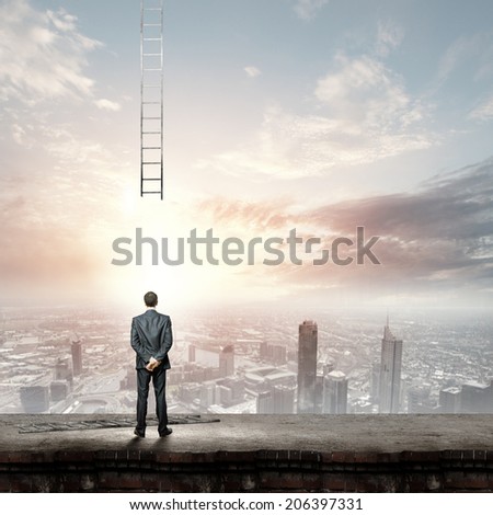 Rear view of businessman looking at broken ladder