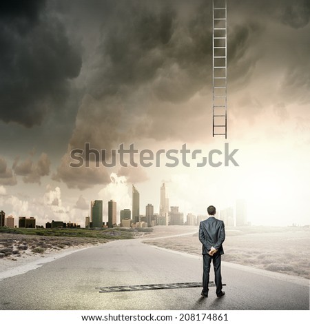 Rear view of businessman looking at broken ladder
