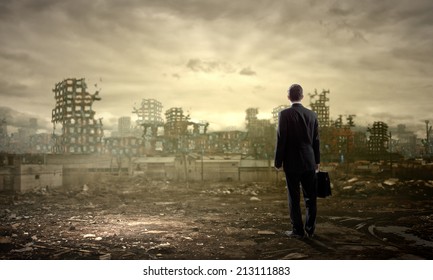 Rear view of businessman looking at ruins of city