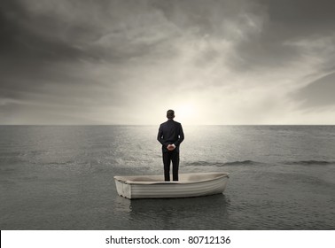 Rear View Of A Businessman On A Boat In The Sea