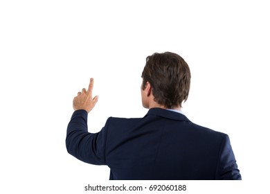 Rear view of businessman pressing an invisible virtual screen against white background - Powered by Shutterstock