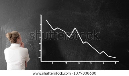 rear view of businesswoman looking at chart with sloping curve, dropping prices business risk concept