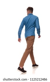 Rear View Of Casual Man Walking And Looking To Side On White Background, Full Length Picture