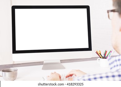 Rear View Of Caucasian Businessperson Typing On Keyboard In Front Of A Blank Computer Screen. Mock Up