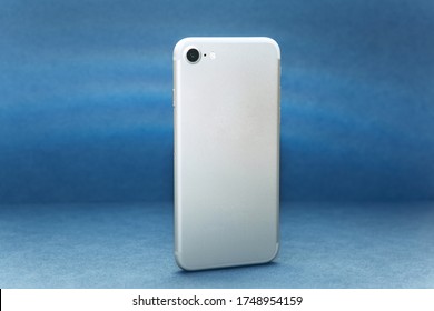 Rear View Cell Phone With Camera On A Blue Background.