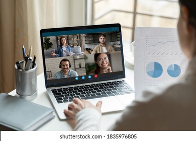 Rear view close up businesswoman brainstorming project statistics with colleagues online, using laptop, group video call, business people engaged in conference, internet negotiations, briefing - Shutterstock ID 1835976805