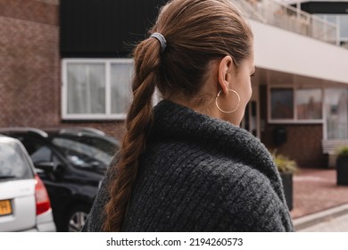 Rear View Of Close Up Portrait Woman Walk Outdoor With High Ponytail Braid And Circle Earrings. Tourist Woman Walk  In City Street.