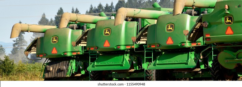 Rear view of combines and a tractor ready for a day of grass seed harvest.  Willamette Valley Oregon - Shutterstock ID 1155490948