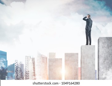 Rear view of a confused businessman scratching his head and thinking. He is standing on a giant bar chart in a city. Mock up toned image - Shutterstock ID 1049164280