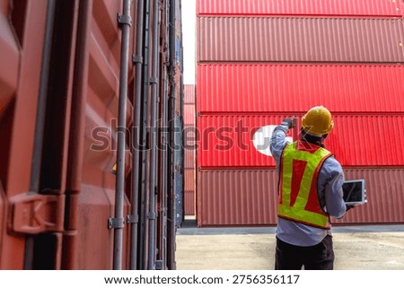 Rear view container worker man checking and counting stack of export containers in international logistic port