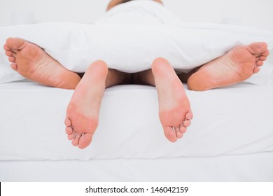Rear view of a couple having sex in bed