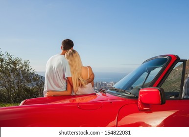 Rear view of couple hugging and admiring panorama on a sunny day - Powered by Shutterstock