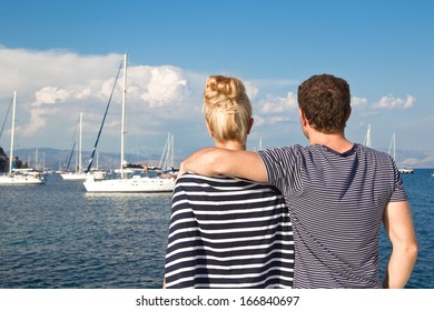 Rear View Of Couple On A Sailing Boat. 