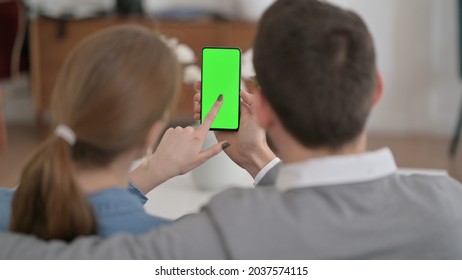 Rear View of Couple using Smartphone with Green Chroma Key Screen - Powered by Shutterstock