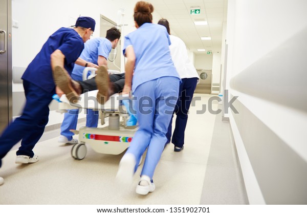 Rear view of\
doctors running for the surgery\
