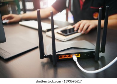 Rear view of Dual Band Router or Wireless AC router with business man using a computer in home office background . Computers and Router wireless broadband Accessories concept                       - Shutterstock ID 1393698617