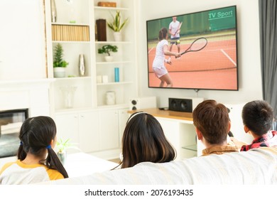 Rear view of family sitting at home together watching tennis match on tv. sports, competition, entertainment and technology concept digital composite image.