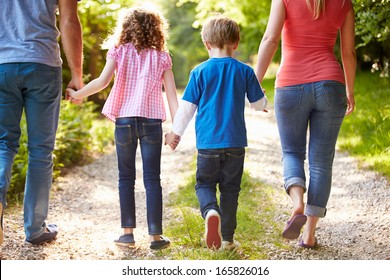 Rear View Of Family Walking In Countryside