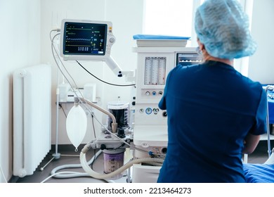 Rear view of female anaesthesiologist with monitor during operating in operation room. Modern equipment in clinic. Emergency room. - Shutterstock ID 2213464273