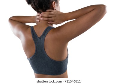 Rear view of female athlete massaging neck against white background - Powered by Shutterstock