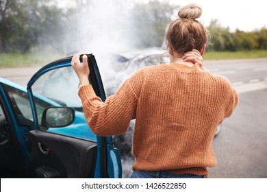 Rear View Of Female Motorist With Head Injury Getting Out Of Car After Crash - Shutterstock ID 1426522850