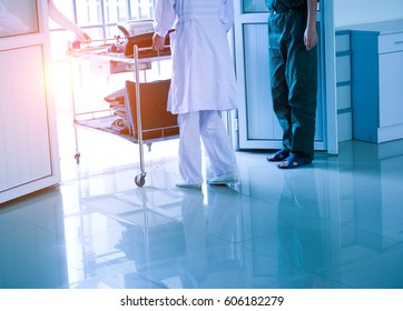 Rear View Of A Female Nurse Walking Out.