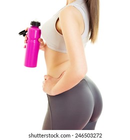 Rear view of fit young woman with water bottle. Closeup studio shot of fitness girl in gray sportswear holding pink bottle, unrecognizable, retouched, isolated on white, square format.