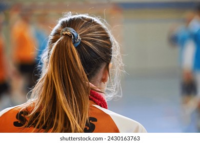 Rear view of a football player girl in a indoor soccer sports center. - Powered by Shutterstock