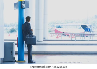 Rear View Full Body Asian Indian Business Man Waiting Bus At Public Bus Station.