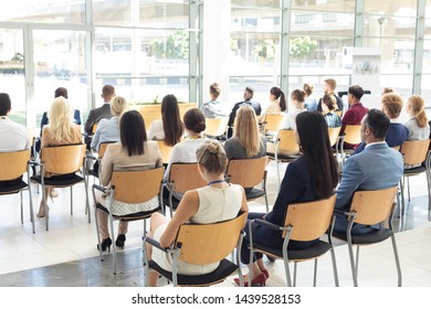 Rear View Of Group Of Diverse Business People Sat In Conference Room