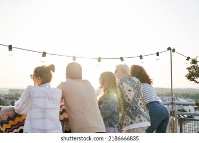 Rear View Of Group Friends At The Party In Top Of The Roof