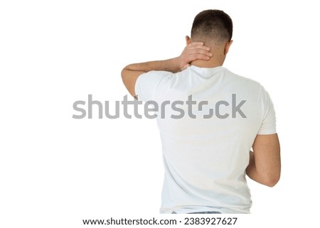 Rear view of a handsome young man in white shirt holding his back and neck in pain isolated on white background, man giving himself a massage on his neck, young man having a back and neck pain