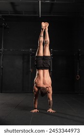 Rear view of handstand exercise, handstand push-ups. Routine workout for physical and mental health.