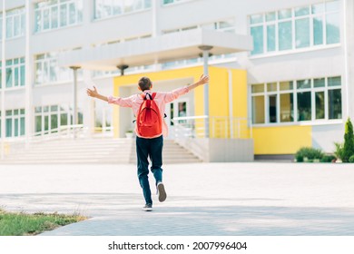 Rear view of a happy schoolboy boy, in glasses with a backpack, runs to school with pleasure, schoolboy boy on the background of the school, Back to school, quarantine, covid - Shutterstock ID 2007996404