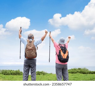 Rear view of Happy Senior couple hiking together on the mountain and coast - Powered by Shutterstock