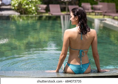 Rear View Of Happy Woman At Spa Swimming Pool