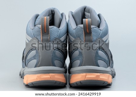 Rear view of hiking shoes isolated on gray studio background