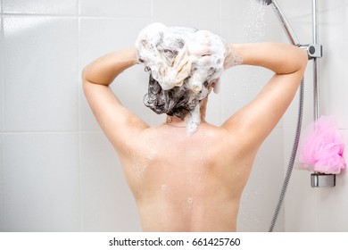 Rear view image of beautiful sexy woman washing head