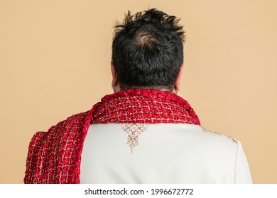 Rear View Of An Indian Man Wearing A Kurta With A Red Scarf