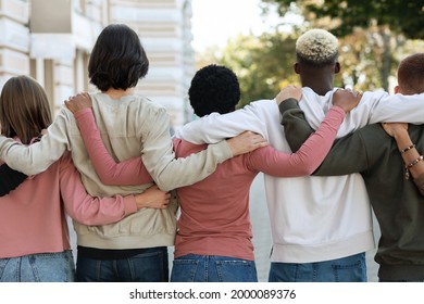 Rear view of international group of people making strike on the street, hugging, showing their strong unity, demanding from government saving planet, reducing pollution. Riot, demonstration, strike - Powered by Shutterstock