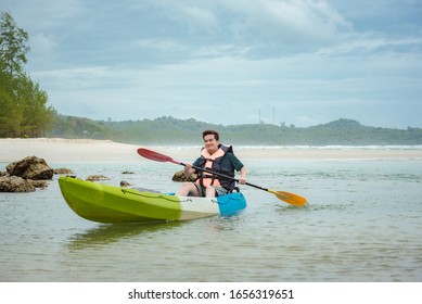 Rear View Of Kayaker Man Paddle Kayak At Sea. Kayaking, Canoeing, Paddling, Man Driving Kayak