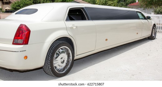 Rear View Of A Long White Limousine Car