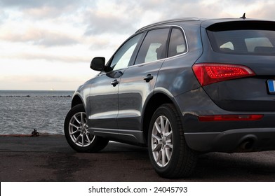 Rear View Of A Luxury SUV Parked Near The Sea