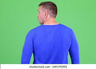 Rear view of macho mature man looking over shoulder - Powered by Shutterstock