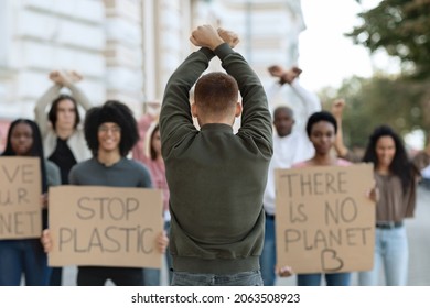 Rear view of male activist leading angry protestors multiracial group of mellannial men and women, multiethnic demonstrators fighting against animal abuse, pollution, striking on the street - Powered by Shutterstock