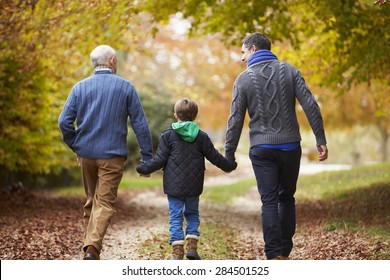 Rear View Of Male Multl Generation Family Walking On Path