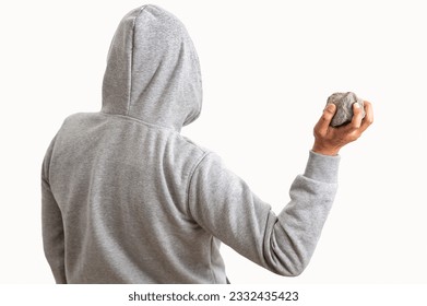 Rear view of a man holding a stone to throw it with white background - Powered by Shutterstock